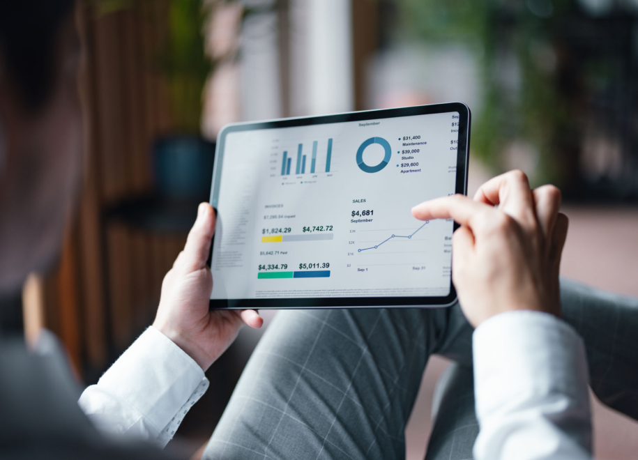 Person analyzing data on a tablet screen.
