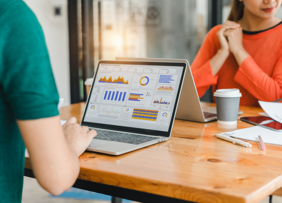 Laptop displaying graphs during a meeting.